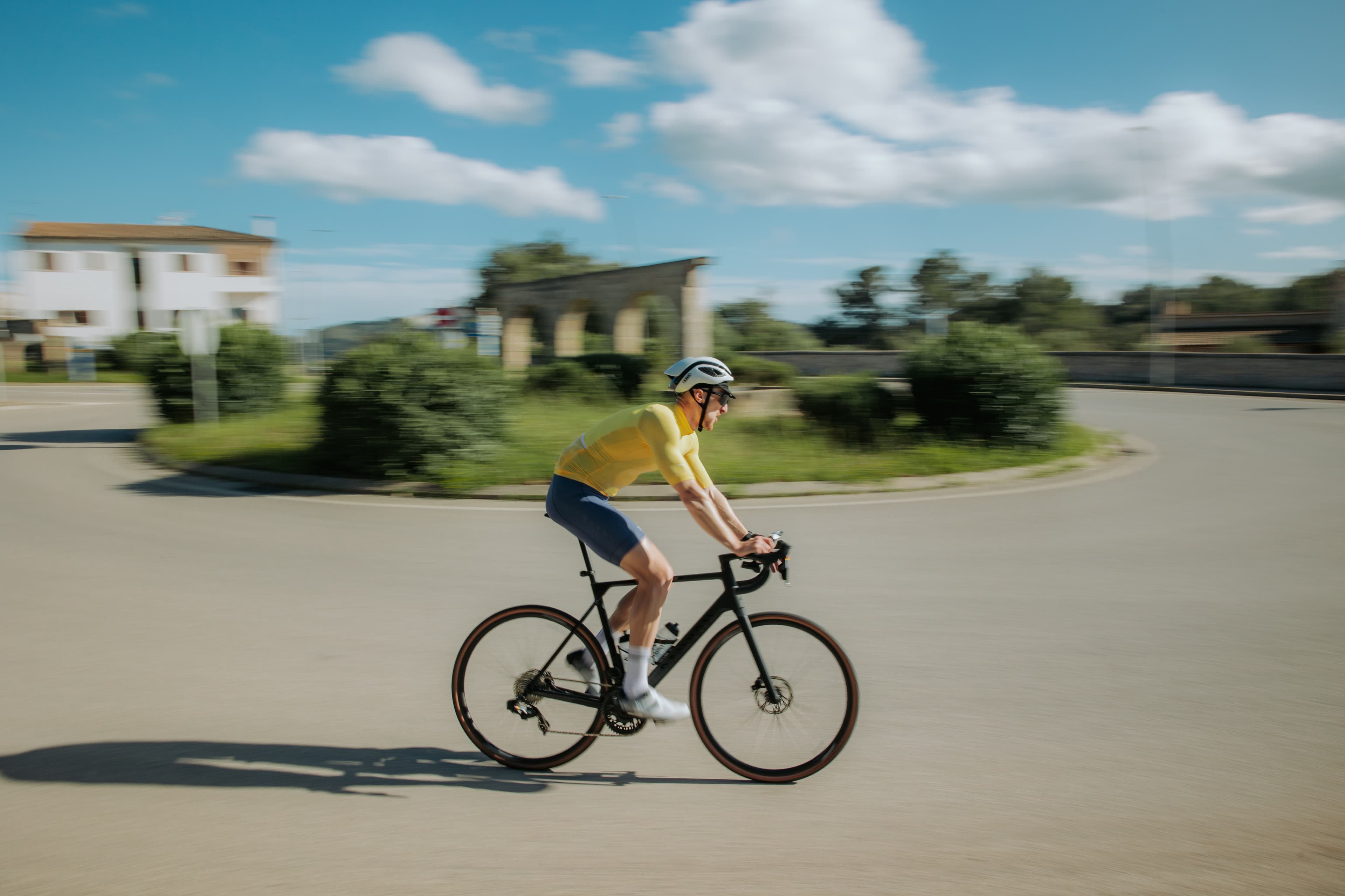 Kevin cycling in yellow jersey with motion blur